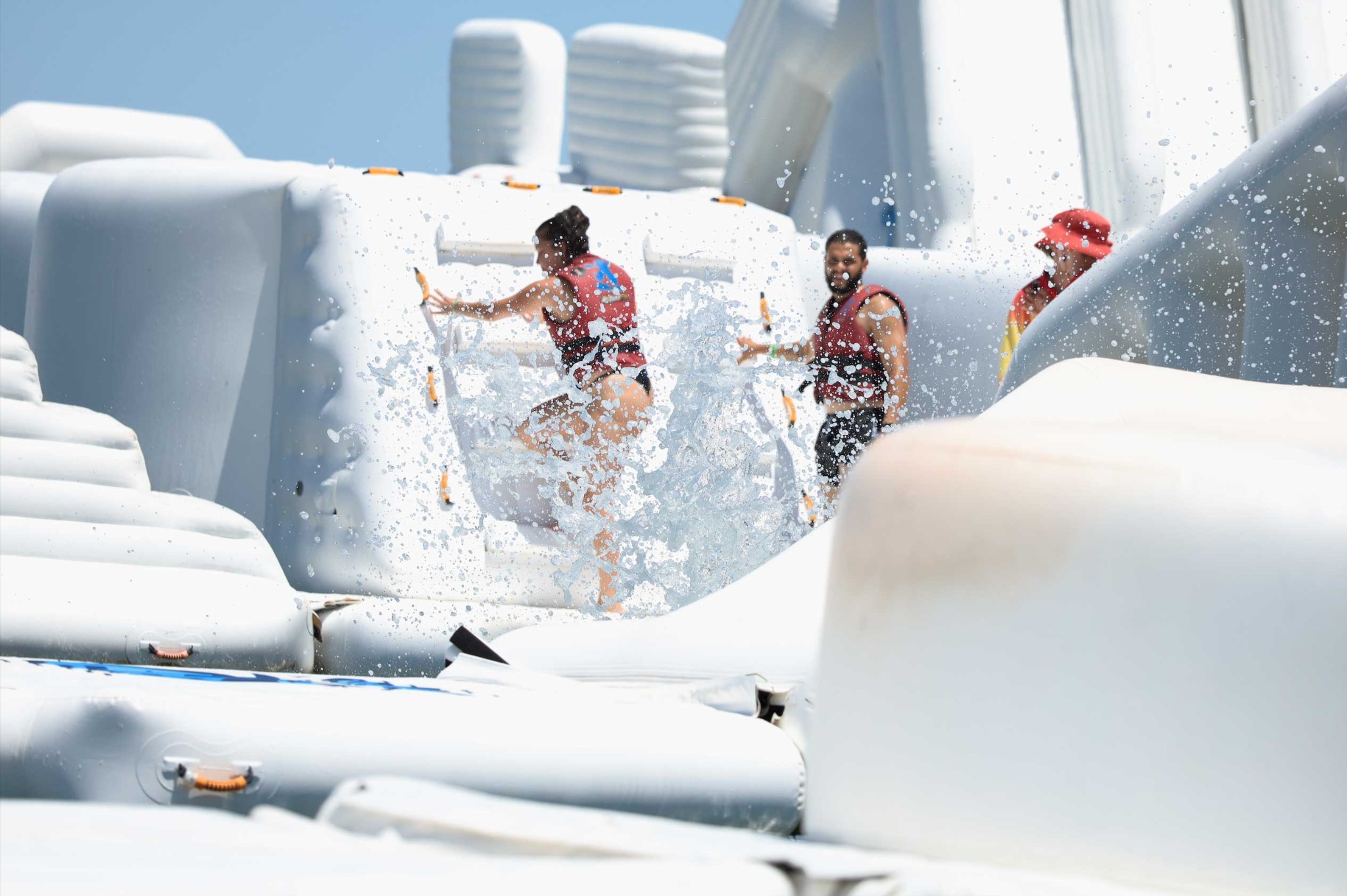 Aqua Warrior participants working together through a splash obstacle